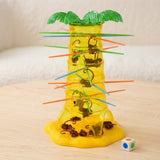 Board game with a translucent yellow plastic palm tree, green leaves, and brown monkeys hanging on colorful sticks on a wooden table.
