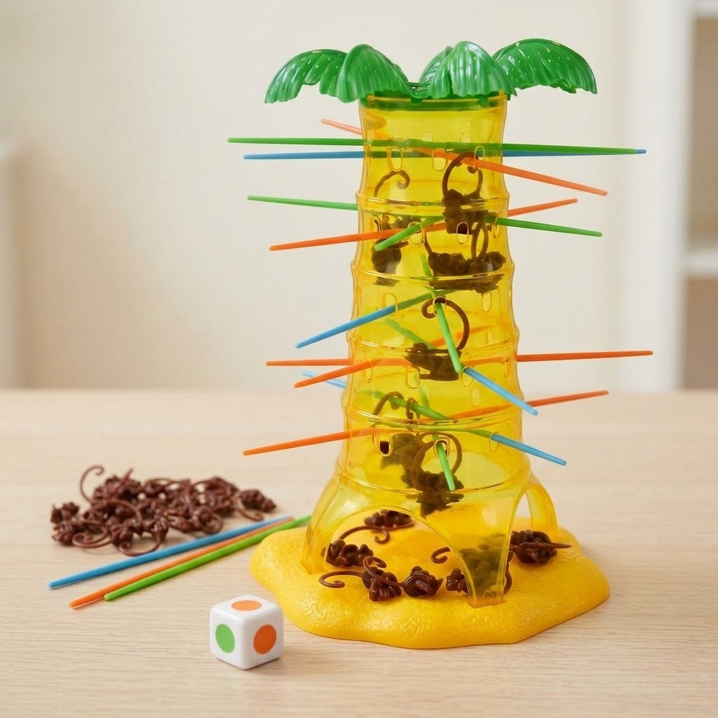 Board game with a translucent yellow plastic palm tree, brown monkeys, colorful sticks, and a die on a light wood tabletop.