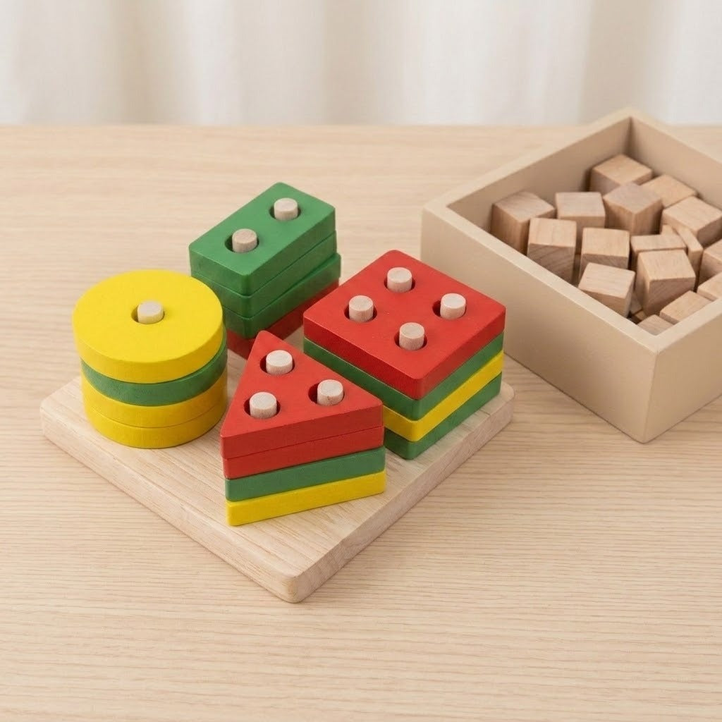 A wooden Montessori-style shape and size sorting toy set on a light wood table, with colorful geometric blocks stacked on a tray and a box of natural wood cubes nearby.