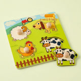 A children's wooden farm-themed puzzle board with colorful animal cutouts and matching pull tabs, shown on a pale yellow background.