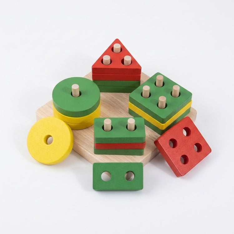 A set of colorful wooden nesting shape-sorting blocks for toddlers, featuring red, green, and yellow pieces with natural wood pegs, displayed on a light wooden tray against a white background.