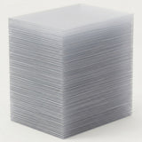 Clear card sleeves form a tall, neatly aligned stack on a plain off-white background.