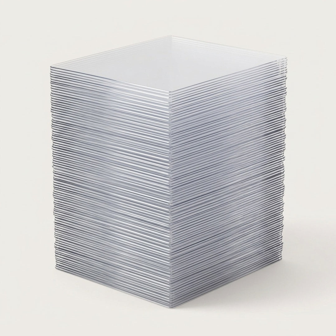 Clear plastic card sleeves form a tall stack with reflective layered edges on a light gray background.