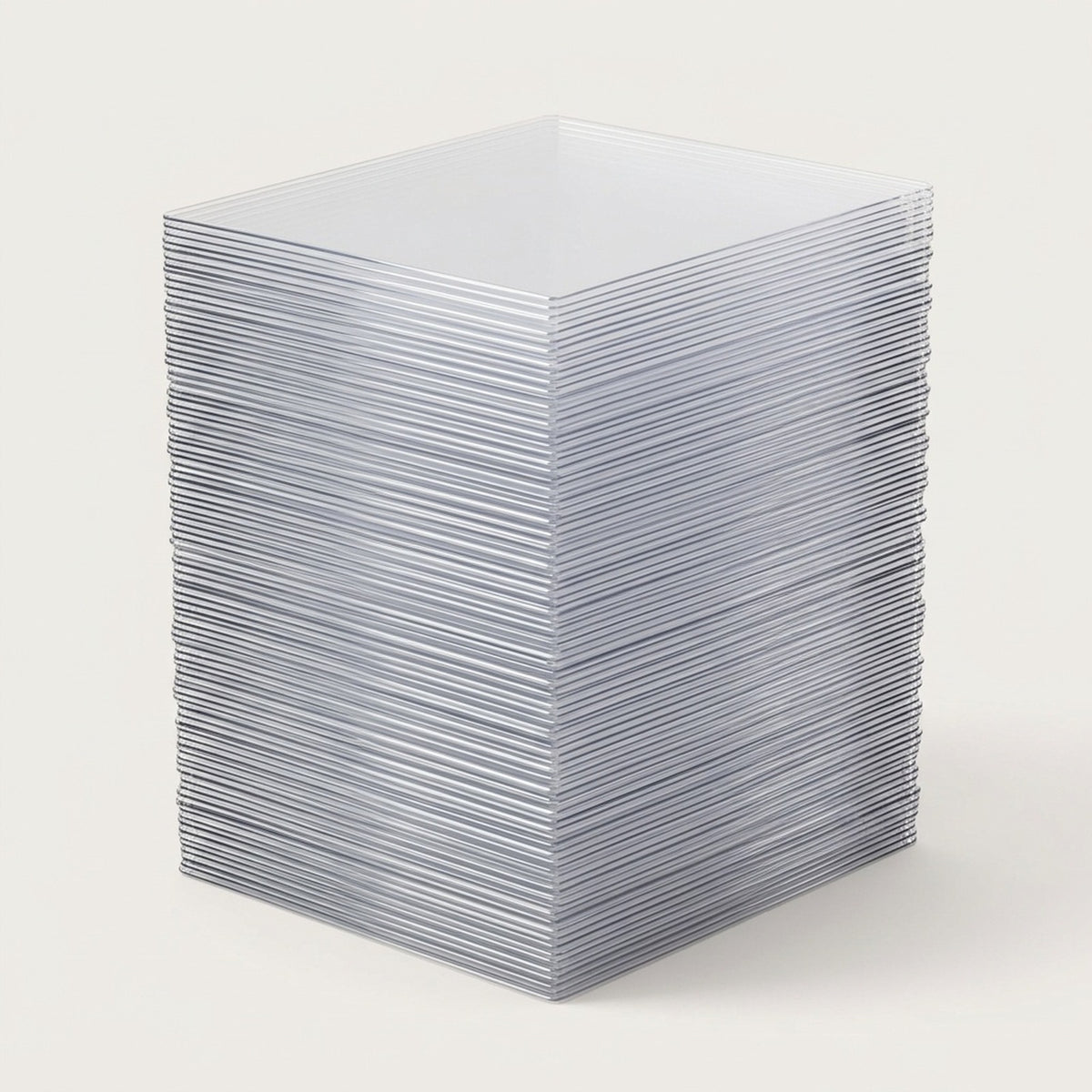 Clear plastic card sleeves form a tall stack with reflective layered edges on a light gray background.