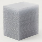 A tall stack of transparent card sleeves displays closely layered edges against a plain light background.