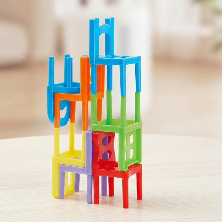 Stacking game pieces shaped like colorful plastic chairs balance upright and upside down on a pale tabletop.