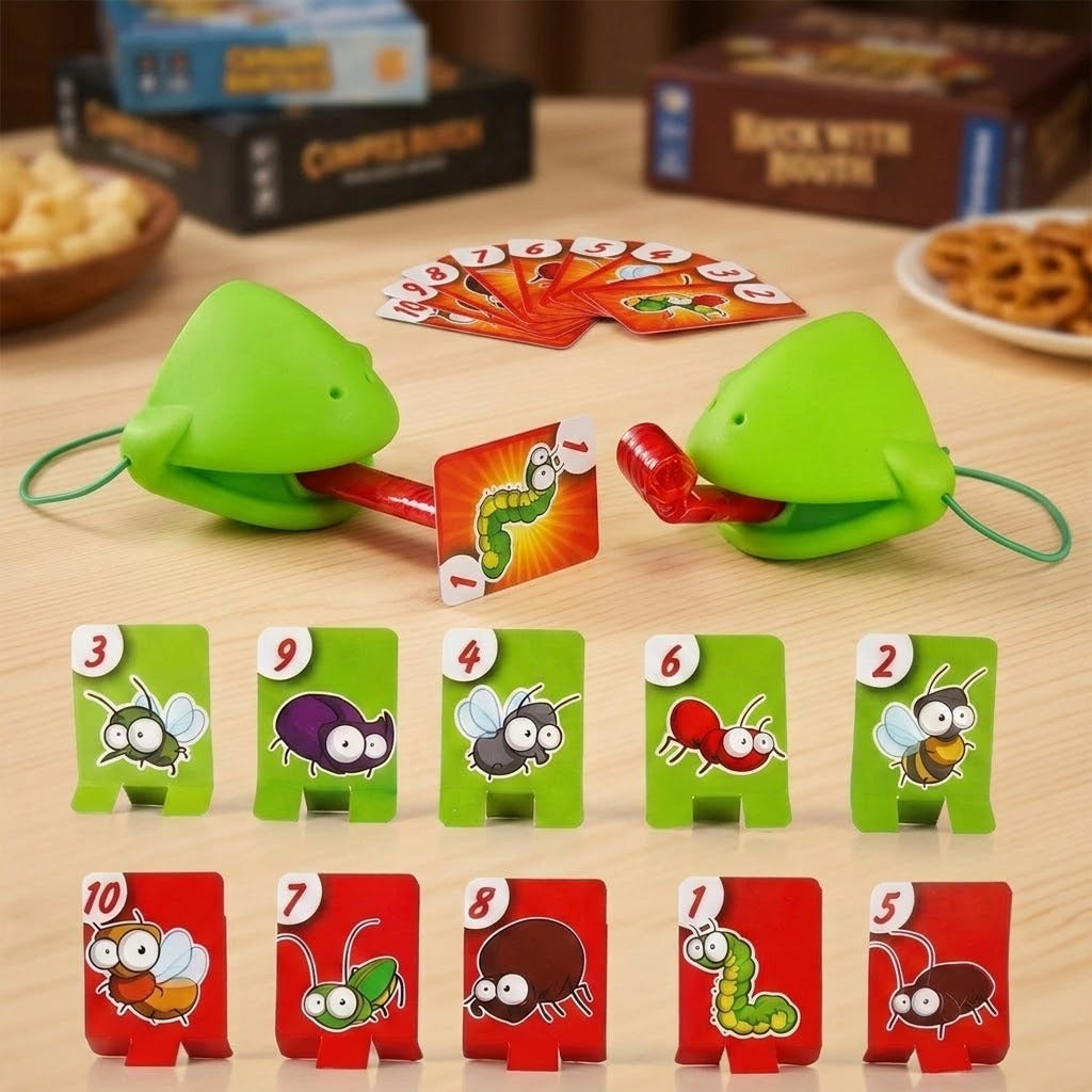 Frog tongue party game with green masks, red tongues, and numbered insect targets on a wooden table beside snacks and game boxes.