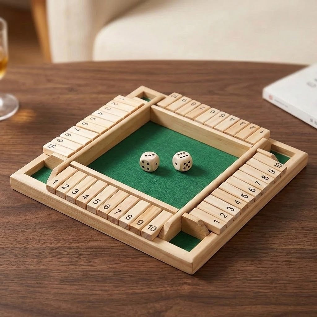 A natural wood four-player shut the box game with green felt and two wooden dice on a dark wooden table.
