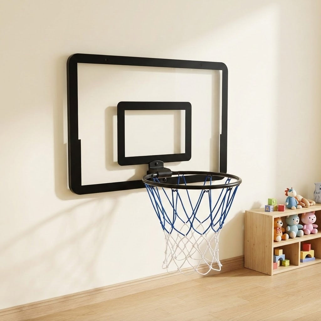 Black mini basketball hoop with blue and white net mounted on a cream playroom wall beside a wooden toy shelf.