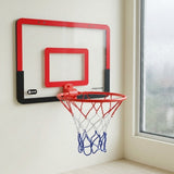 Red and black mini basketball hoop with a red, white, and blue net mounted beside a rain-speckled window.