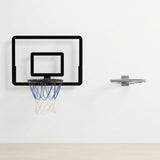 Black-bordered basketball hoop with a clear backboard and blue and white net hangs on a white wall beside a separate grey rim.