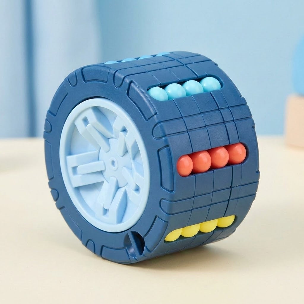 Blue cylinder fidget puzzle with a pale blue wheel end and turquoise, coral and yellow beads on a cream surface.