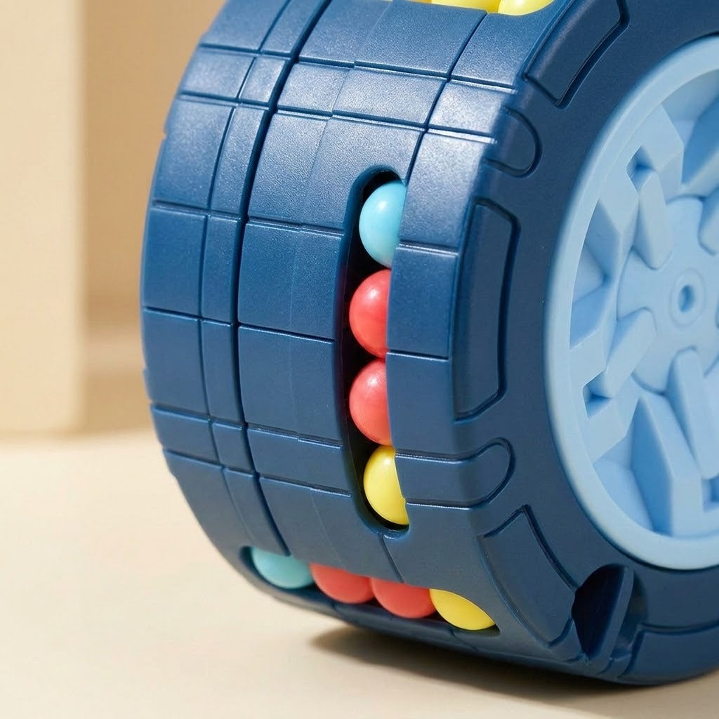 Close-up of a blue fidget puzzle showing segmented grooves, colorful beads and part of its pale blue wheel end.