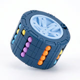Blue cylinder fidget puzzle tilted on a white surface, showing its pale blue wheel end and purple, orange and turquoise beads.