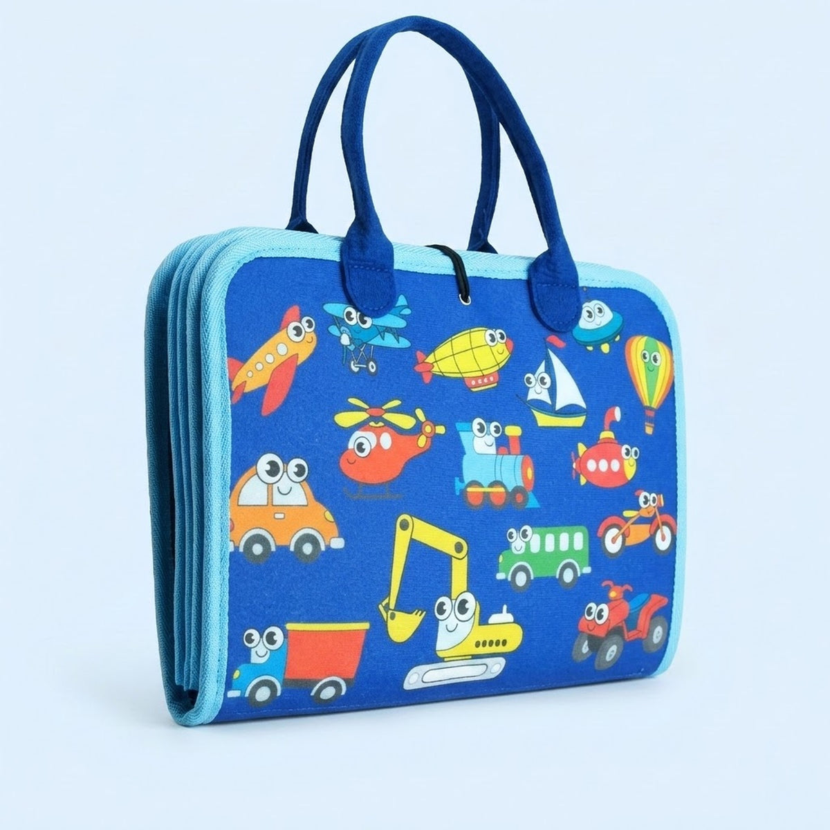 A folded blue fabric busy board with navy handles, light blue trim and colourful vehicle illustrations stands against a pale blue background.