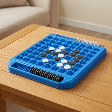 Blue plastic reversi game with black and white discs and edge storage slots on a wooden coffee table beside a beige sofa.