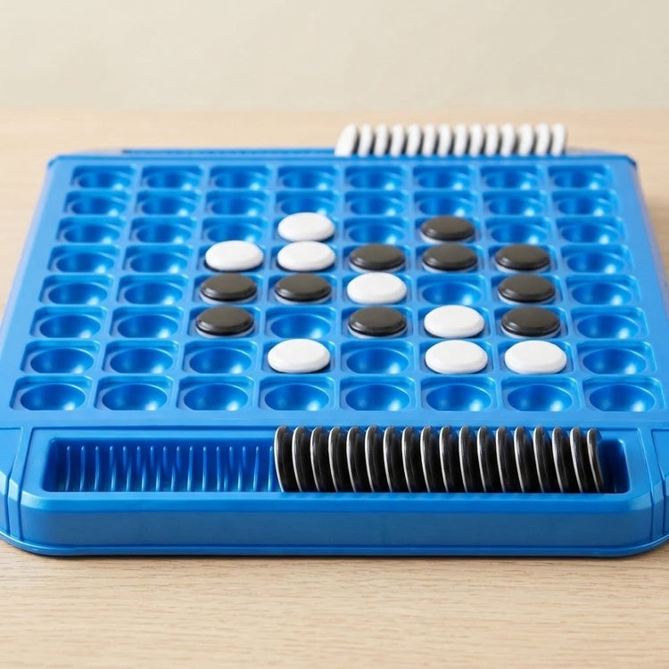 Blue plastic reversi game on a wooden table, with black and white discs on the board and upright discs in storage slots.