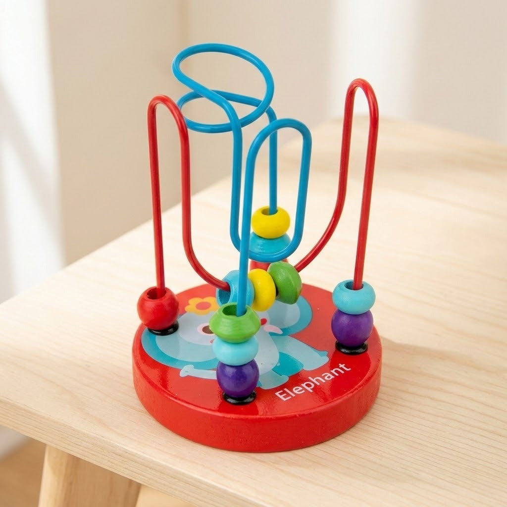 Wooden bead maze learning toy with turquoise and red wires and colorful beads stands on a light wooden stool against a cream background.