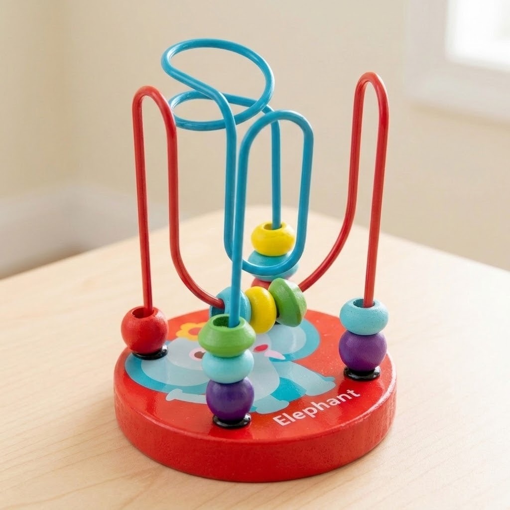 Wooden bead maze learning toy with colorful beads and a red elephant base sits on a pale wooden table beside a window.