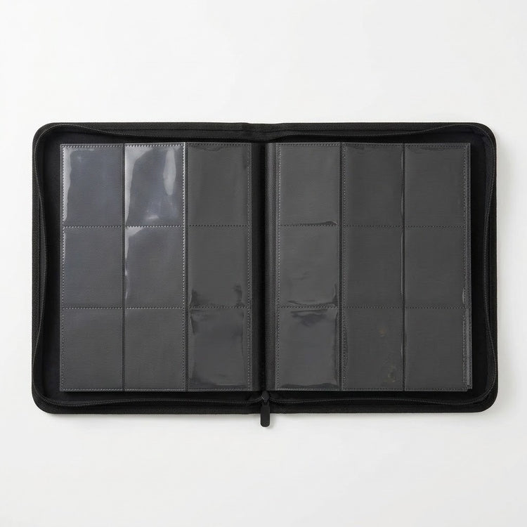 A black trading card binder lies open on a white background, showing two pages with nine clear pockets each.