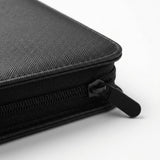 A close-up shows the black trading card binder's textured PU cover, stitched corner, and zipper pull against a white background.