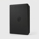 A black trading card binder with a textured PU cover and closed zipper stands upright against a light gray background.