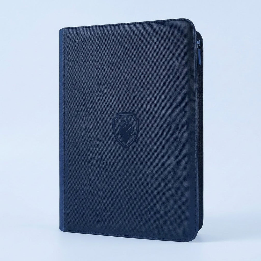 Navy blue textured trading card binder with zipper, shown closed with an embossed shield emblem on a pale blue background.