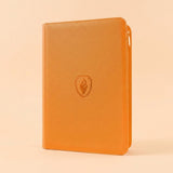 Orange PU leather trading card binder with zipper closure standing upright against a plain light beige background.