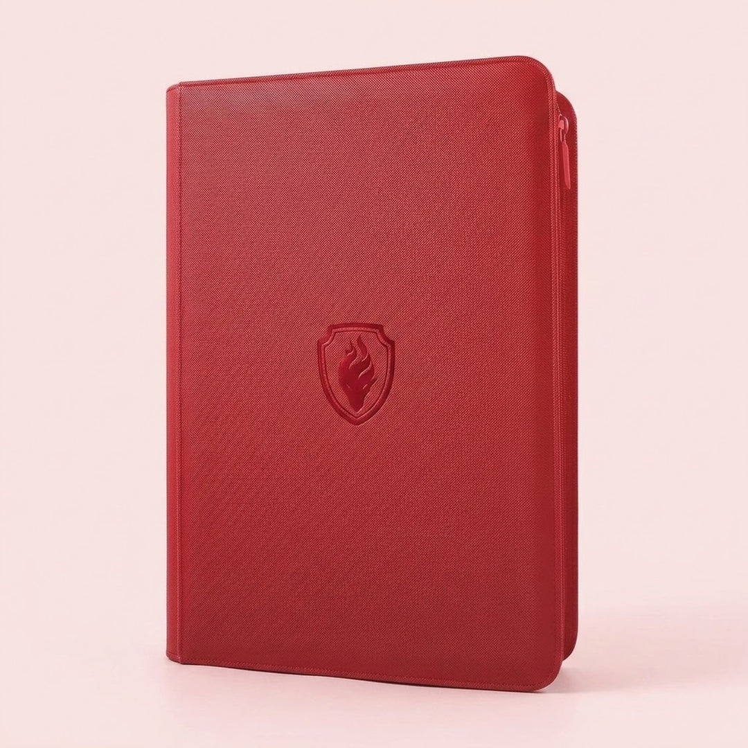A red trading card binder with a textured PU cover and closed zipper stands upright against a pale pink background.