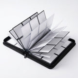 An open black trading card binder rests on a white background with its empty clear pocket pages fanned upright.