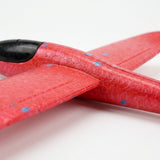 Close-up of the red foam glider option for an airplane launcher toy, showing textured wings, blue flecks, and black cockpit against white.