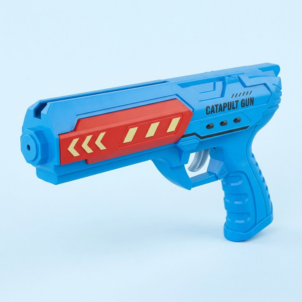 Blue plastic airplane launcher toy with a red side panel, yellow arrows, and gray trigger against a pale blue background.