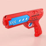 Red airplane launcher toy with a blue side panel, white arrow details, and blue trigger stands against a pink background.