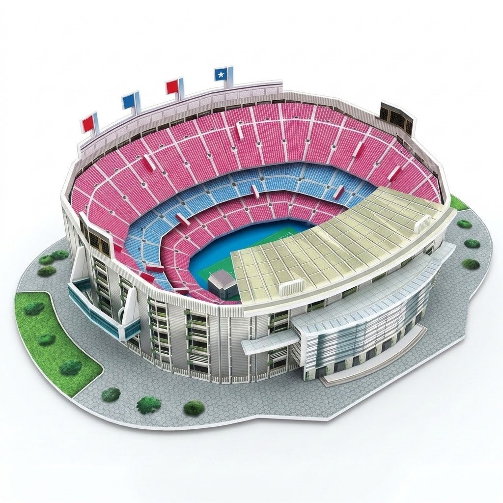 An assembled plastic 3D stadium puzzle features pink and blue seating, gray exterior walls and a landscaped base against a white background.