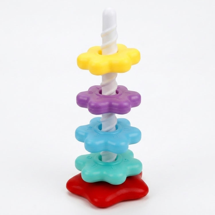 A plastic stacking toy has yellow, purple, blue and mint flower-shaped pieces along a white spiral post on a red base against white.