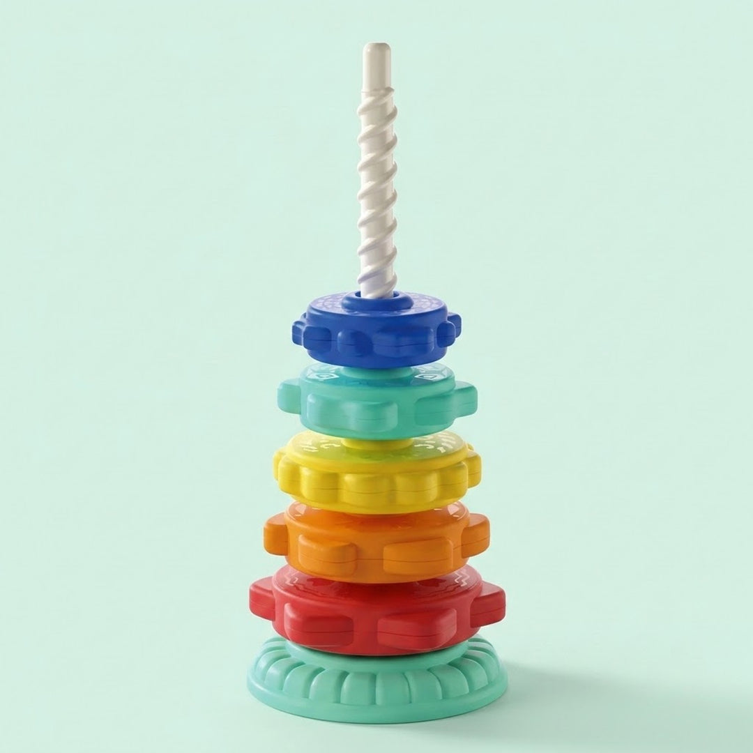 A stacking toy with blue, mint, yellow, orange and red rings on a white spiral post stands against a pale mint background.