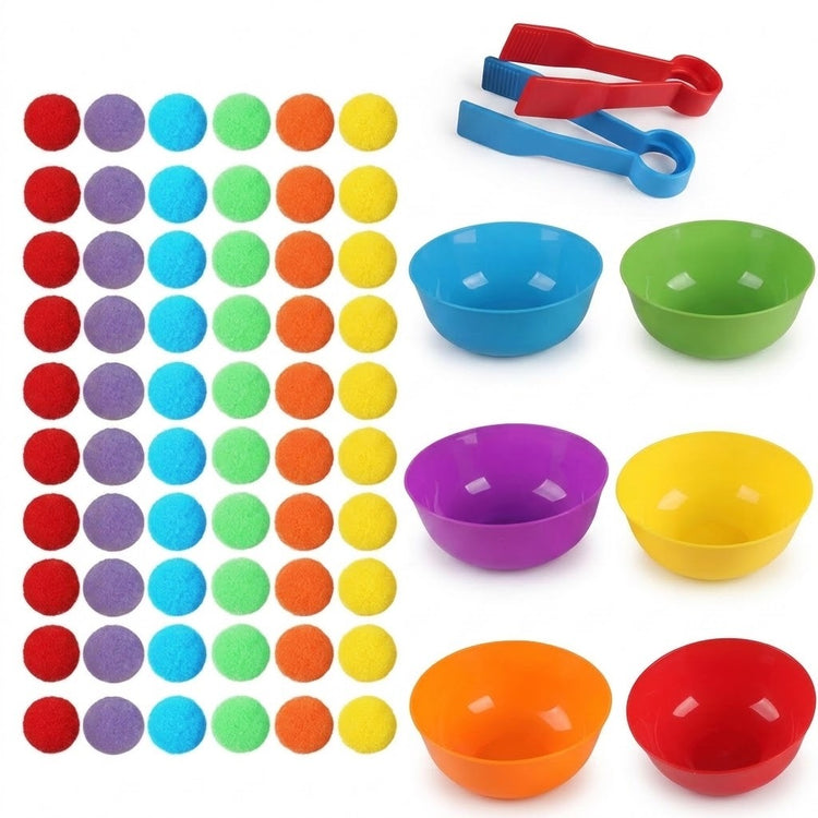 Sorting toy set with pom-poms arranged in six colored columns beside six empty plastic bowls and two tweezers on white.