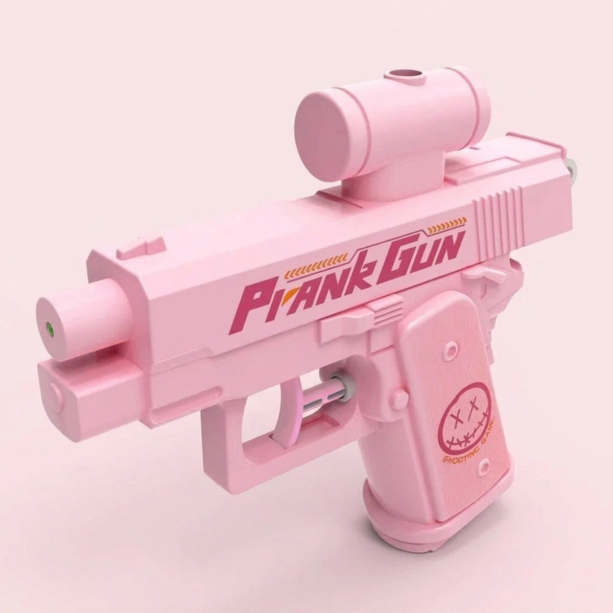 A pink water gun with a cylindrical top attachment and cartoon face on the grip stands against a pale pink background.