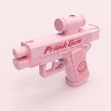 A pink water gun with a cylindrical top attachment and curved trigger stands against a pale pink background.