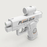 A white plastic water gun with black and orange lettering and a face graphic stands against a light background.