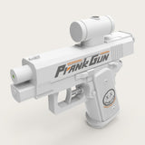 A white water gun with black and orange side graphics and a cylindrical top attachment stands against a light beige background.