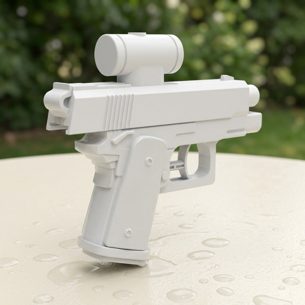 A white plastic toy blaster gun with a cylindrical sight, standing on a wet light-colored surface with water droplets, set against a blurred green outdoor background.
