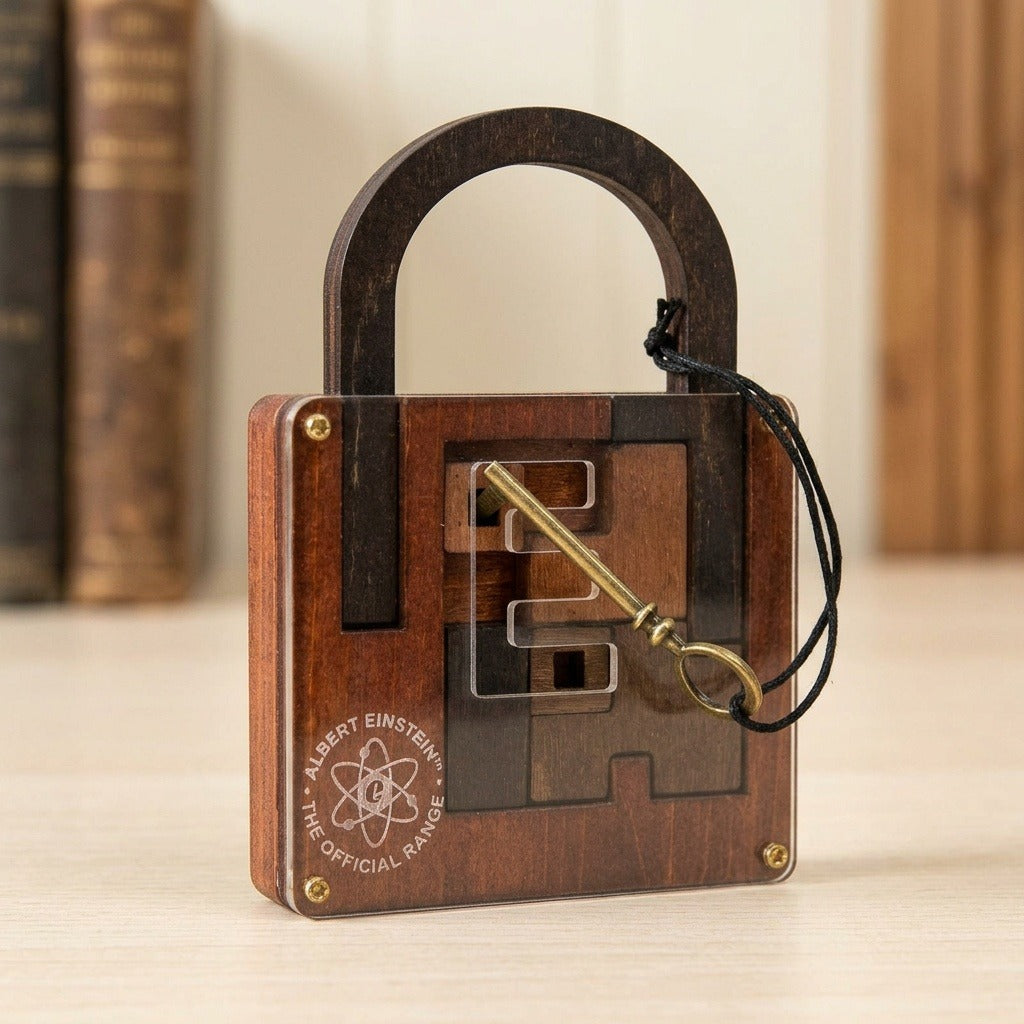 Brown wooden lock puzzle stands on a pale tabletop with its brass-coloured key across the clear front and blurred books behind.