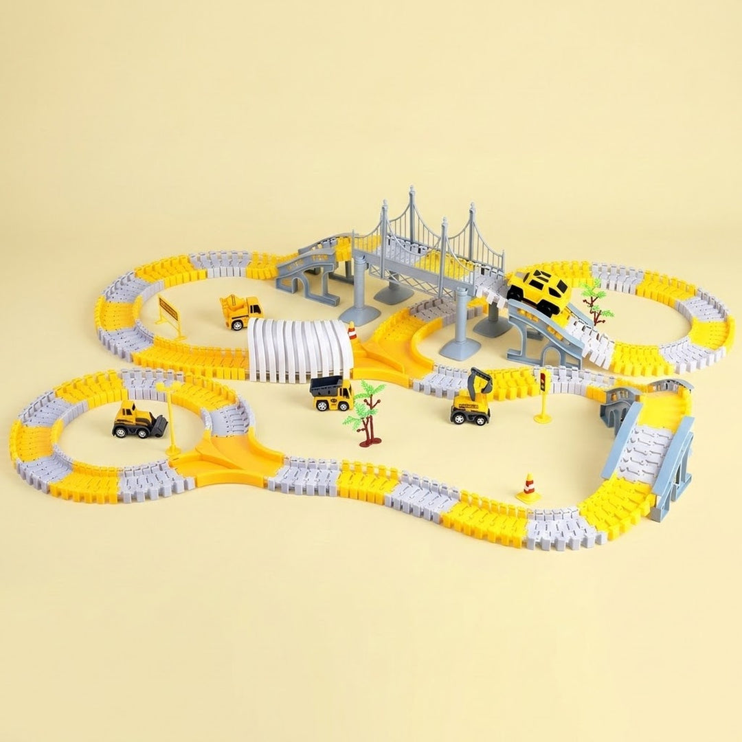 Yellow and gray car track set with bridges, a ribbed tunnel, yellow mini car, and miniature construction vehicles against a pale yellow background.