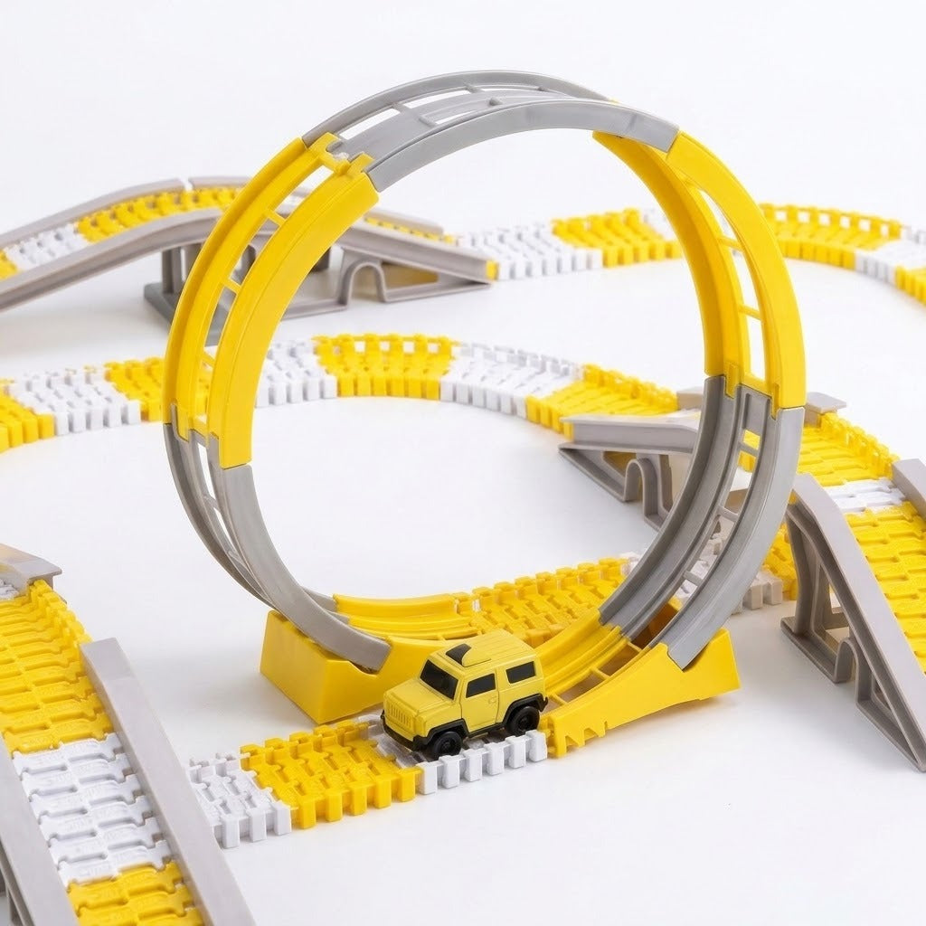 A yellow and gray plastic toy train track set with a small yellow car, photographed on a clean white background.