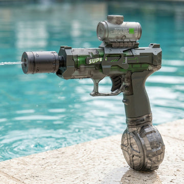 A translucent gray electric water gun sprays water while standing on a pale stone deck beside a turquoise swimming pool.