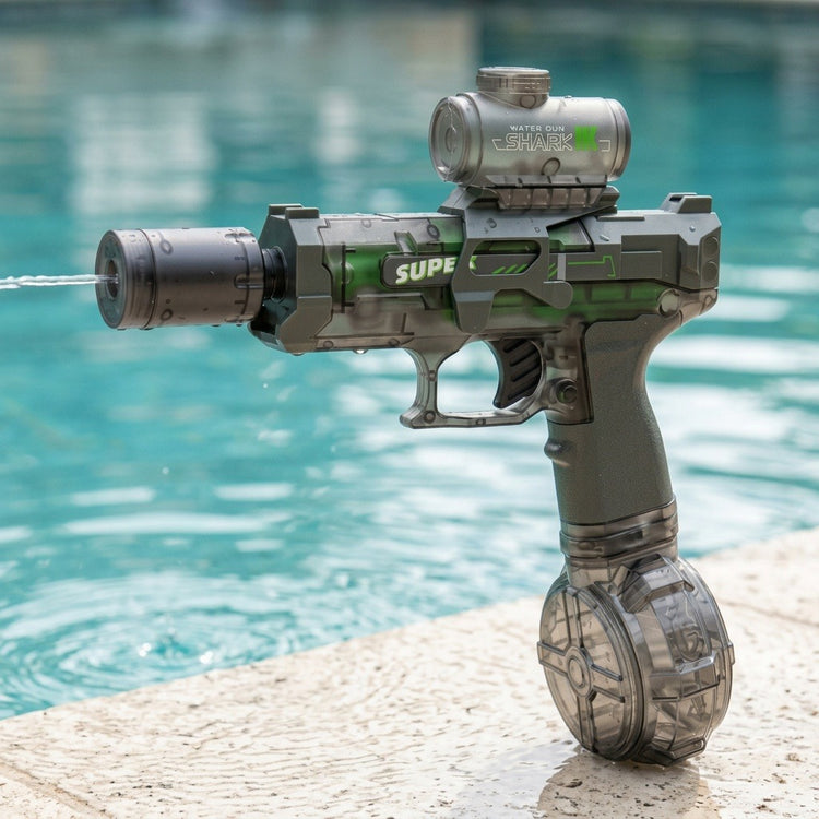 A translucent gray electric water gun sprays water while standing on a pale stone deck beside a turquoise swimming pool.