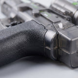 A close-up shows the electric water gun’s black textured grip and translucent gray plastic body against a light gray background.