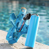 A translucent blue electric water gun rests beside a pool with its battery compartment open and wired blue battery exposed.