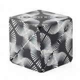 A closed puzzle cube with black and white radiating lines and nested diamond patterns stands against a white background.